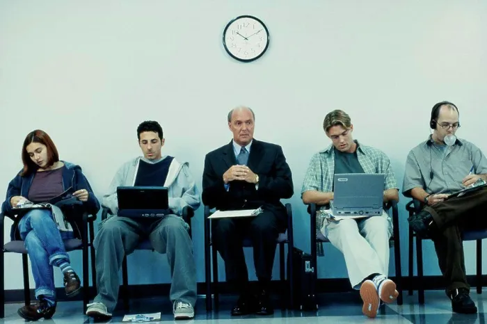 Framed Print : Business executives sitting in a row operating laptops Framed Print : Business executives sitting in a row operating laptops
