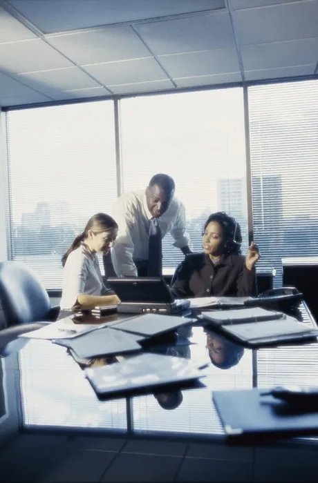 Framed Print : Three business executives working in an office Framed Print : Three business executives working in an office
