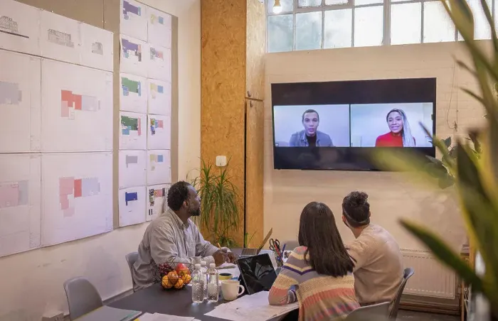 Framed Print : Business people video conferencing with colleagues in meeting Framed Print : Business people video conferencing with colleagues in meeting
