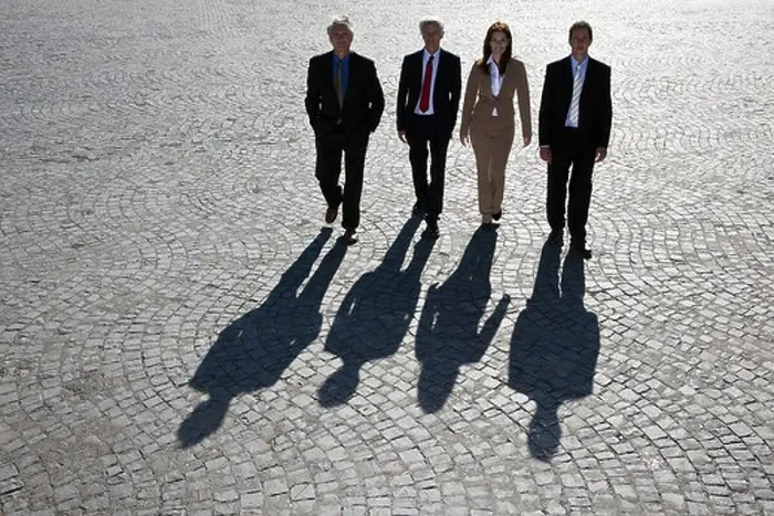 Framed Print : Business people walking on cobbled road Framed Print : Business people walking on cobbled road