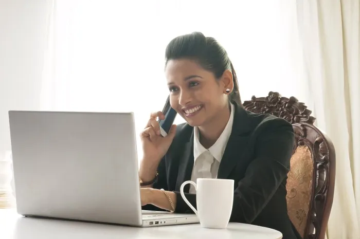 Framed Print : Business woman using mobile phone at desk Framed Print : Business woman using mobile phone at desk
