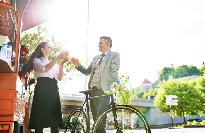 Framed Print : Businessman with bicycle buying take away coffee on the street