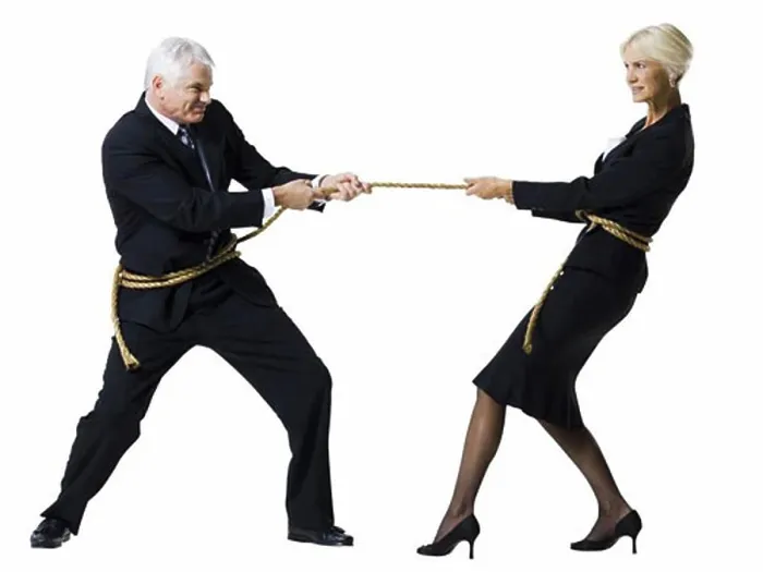 Framed Print : Businessman and businesswoman in a tug of war Framed Print : Businessman and businesswoman in a tug of war