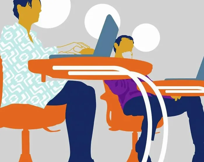 Framed Print : Businessman and businesswoman using laptops at classroom desks Framed Print : Businessman and businesswoman using laptops at classroom desks