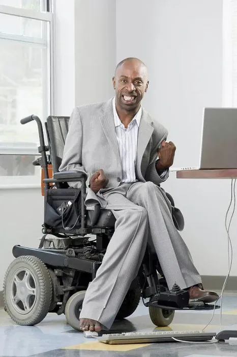Framed Print : Businessman with Cerebral Palsy working on a computer with his foot Framed Print : Businessman with Cerebral Palsy working on a computer with his foot
