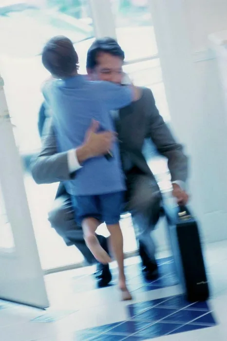 Framed Print : Businessman hugging his son at the door Framed Print : Businessman hugging his son at the door