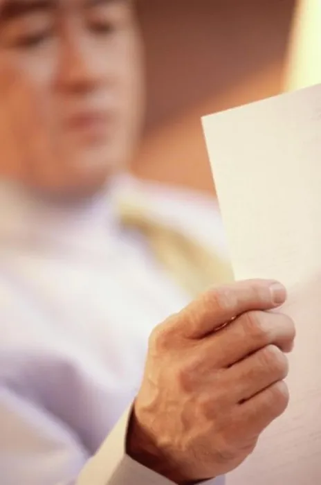 Framed Print : Businessman reading a sheet of paper Framed Print : Businessman reading a sheet of paper