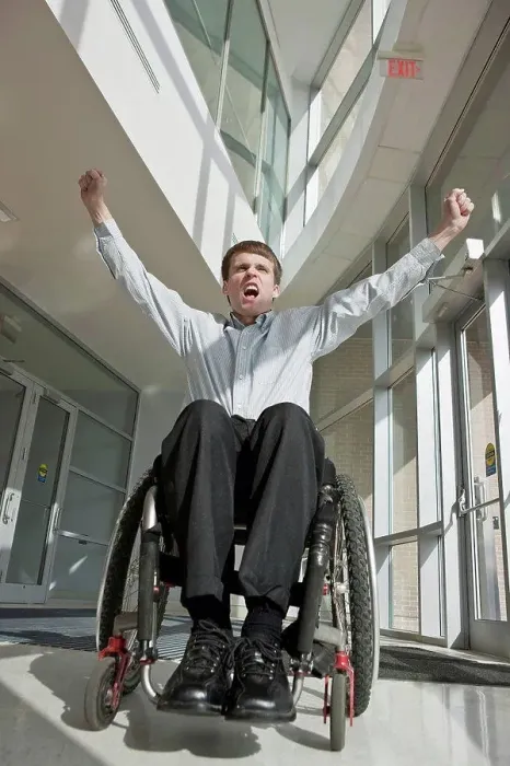 Framed Print : Businessman with spinal cord injury in a wheelchair with his arms raised Framed Print : Businessman with spinal cord injury in a wheelchair with his arms raised