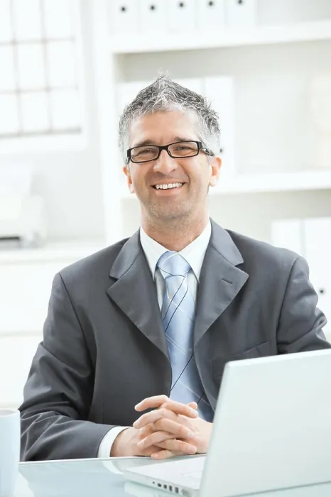Framed Print : Businessman thinking Businessman sitting at office desk working on laptop computer