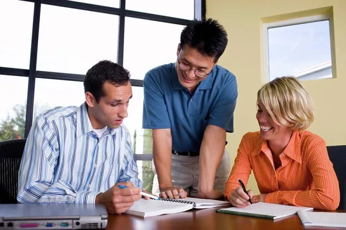 Framed Print : Two businessmen and a businesswoman reading documents Framed Print : Two businessmen and a businesswoman reading documents
