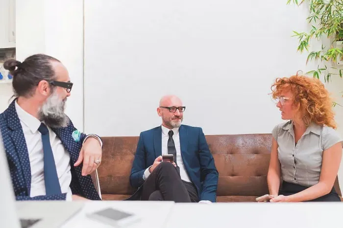 Framed Print : Businessmen and woman meeting on office sofa Framed Print : Businessmen and woman meeting on office sofa