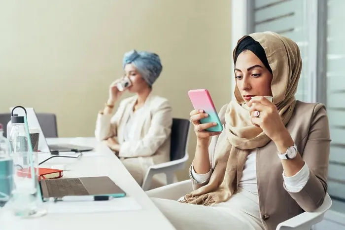Framed Print : Businesswoman in office, using phone Framed Print : Businesswoman in office, using phone