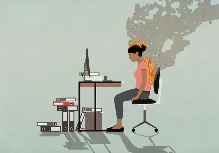 Framed Print : Businesswoman sitting at desk with back and head burning Framed Print : Businesswoman sitting at desk with back and head burning