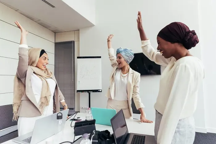 Framed Print : Businesswomen raising arms together