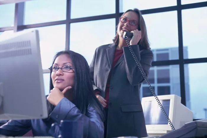 Framed Print : Two businesswomen working in an office Framed Print : Two businesswomen working in an office