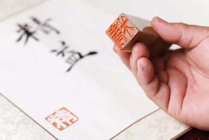 Framed Print : Calligrapher holding a stamp