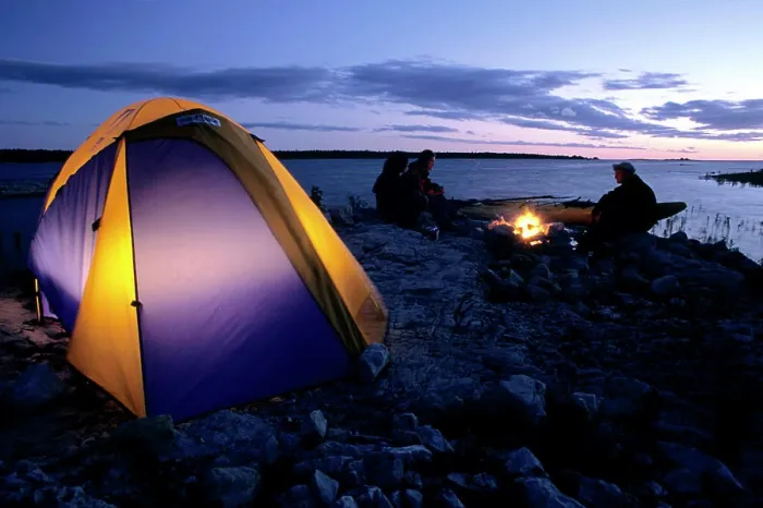 Framed Print : Campers enjoy a fire on the shore of Lake Huron at sunset, near the town of Tobermory, Bruce Peninsula, Ontario, Canada
