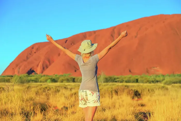 Framed Print : Carefree tourist woman with raised arms enjoys Uluru (Ayers Rock) at sunset in Uluru-Kata Tjuta National Park Framed Print : Carefree tourist woman with raised arms enjoys Uluru (Ayers Rock) at sunset in Uluru-Kata Tjuta National Park