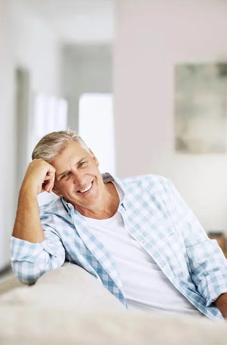 Framed Print : Casual, relaxed and happy mature man smiling indoors on his couch at home on a relaxing day Framed Print : Casual, relaxed and happy mature man smiling indoors on his couch at home on a relaxing day