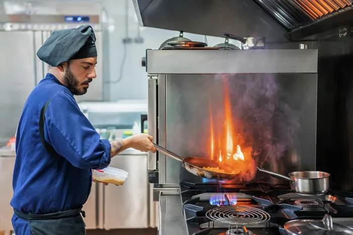 Framed Print : Chef cooking with flame in frying pan Framed Print : Chef cooking with flame in frying pan