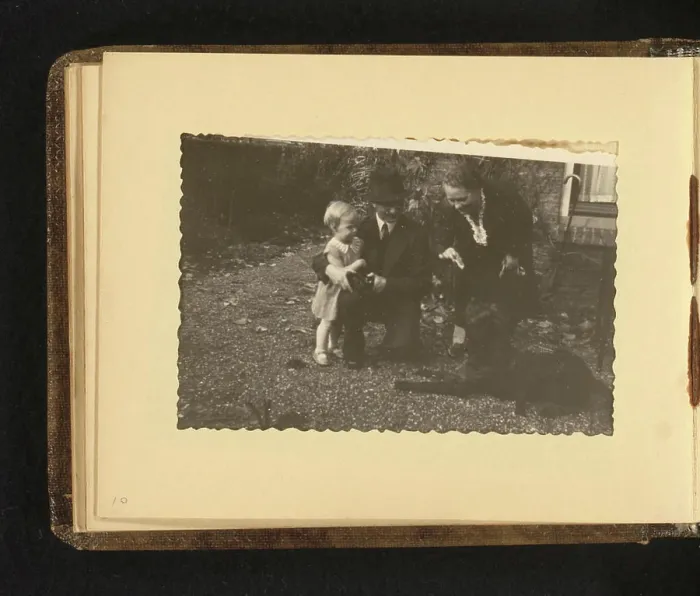 Framed Print : Child with dog, Anonymous, 1938 photograph Album magazine with a photo of a child with a dog and two adults Framed Print : Child with dog, Anonymous, 1938 photograph Album magazine with a photo of a child with a dog and two adults