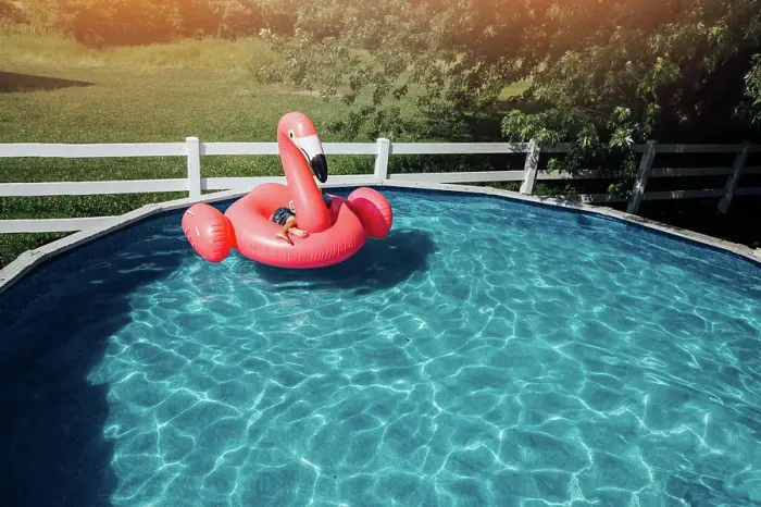 Framed Print : child on giant flamingo floatie in pool Framed Print : child on giant flamingo floatie in pool