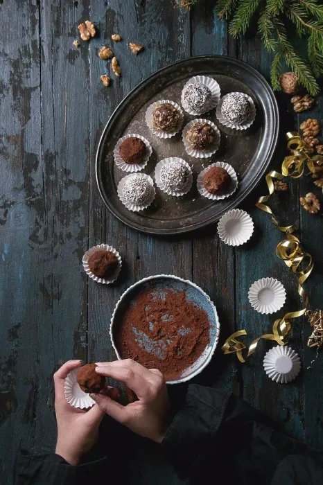 Framed Print : Child hands make homemade dark chocolate truffles with cocoa powder