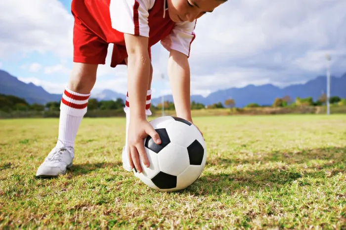 Framed Print : Child, hands and soccer ball for sports on green grass in training or practice with clouds and blue sky Framed Print : Child, hands and soccer ball for sports on green grass in training or practice with clouds and blue sky