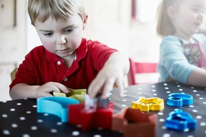 Framed Print : Children playing with shapes on table
