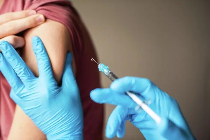 Framed Print : Close up of arm of boy getting vaccinated by doctor holding a needle Framed Print : Close up of arm of boy getting vaccinated by doctor holding a needle
