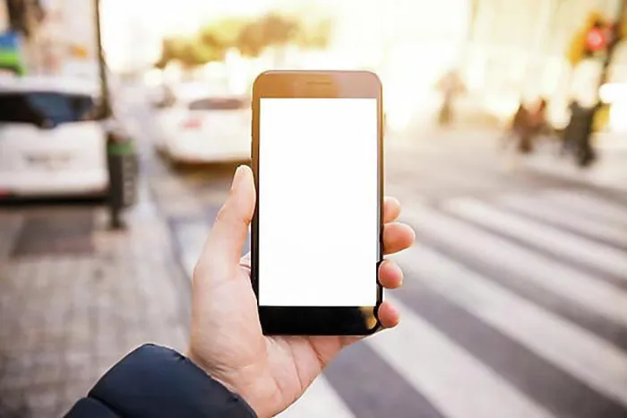 Framed Print : Close up mans hand showing mobile phone with white screen display road Framed Print : Close up mans hand showing mobile phone with white screen display road