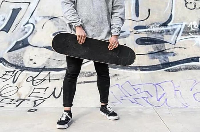 Framed Print : Close up of unrecognizable young man holding longboard or skateboard in the park Framed Print : Close up of unrecognizable young man holding longboard or skateboard in the park