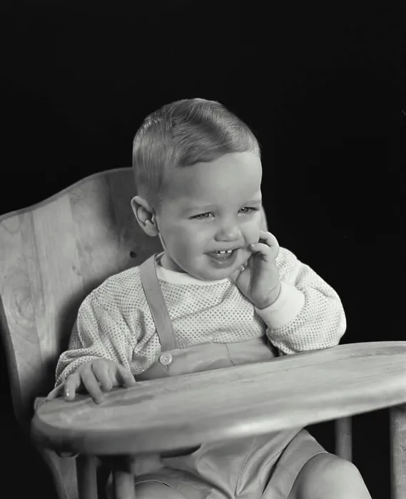 Framed Print : Close-up of a baby sitting in a high chair and smiling Framed Print : Close-up of a baby sitting in a high chair and smiling