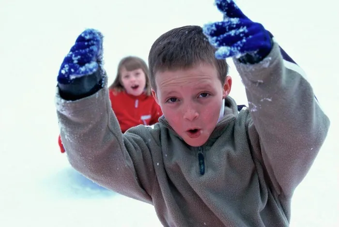 Framed Print : Close-up of a boy playing with snow Framed Print : Close-up of a boy playing with snow