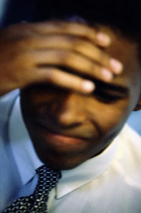 Framed Print : Close-up of a businessman with his hand on his head Framed Print : Close-up of a businessman with his hand on his head