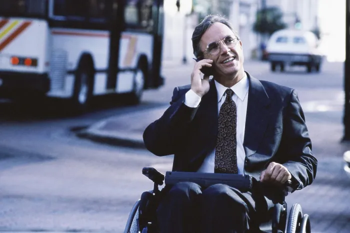 Framed Print : Close-up of a businessman in a wheelchair talking on a mobile phone Framed Print : Close-up of a businessman in a wheelchair talking on a mobile phone