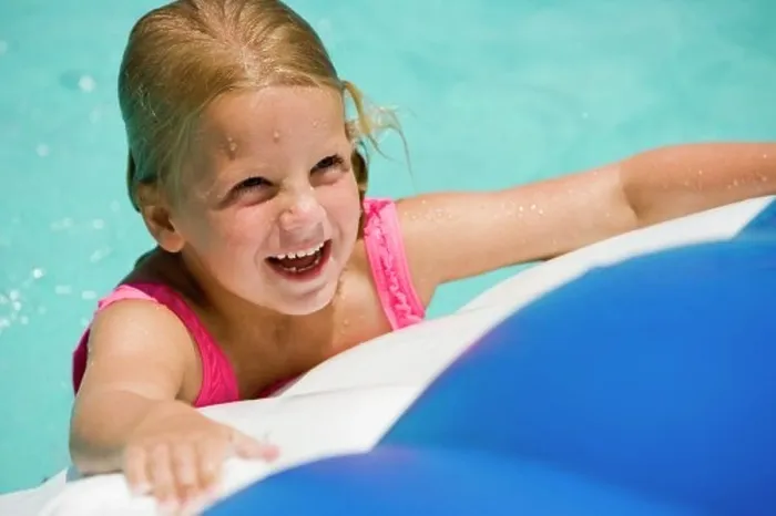 Framed Print : Close-up of a cheerful girl looking up at swimming pool Framed Print : Close-up of a cheerful girl looking up at swimming pool