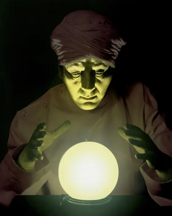 Framed Print : Close-up of a fortune teller looking into a crystal ball