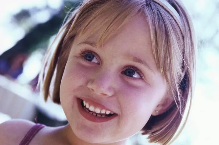 Framed Print : Close-up of a girl smiling Framed Print : Close-up of a girl smiling