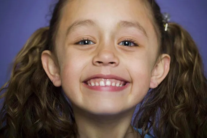 Framed Print : Close-up of a girl smiling Framed Print : Close-up of a girl smiling