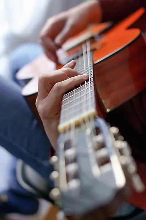 Framed Print : Close-up of a mans hands playing the spanish guitar selective approach