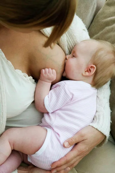 Framed Print : Close-up of a mid adult woman breastfeeding her daughter Framed Print : Close-up of a mid adult woman breastfeeding her daughter