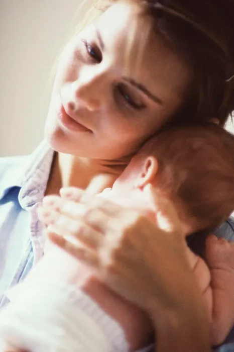 Framed Print : Close-up of a mother carrying her baby boy Framed Print : Close-up of a mother carrying her baby boy