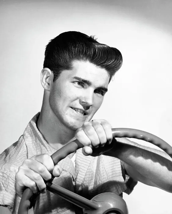 Framed Print : Close-up of a young man holding a steering wheel Framed Print : Close-up of a young man holding a steering wheel