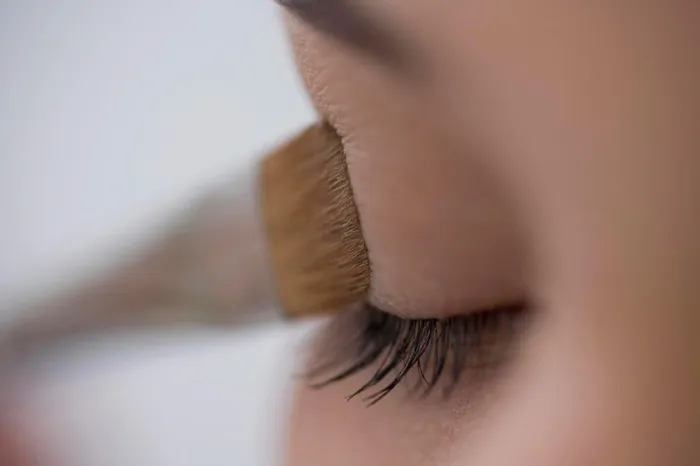 Framed Print : Close up of young woman eye with eyeshadow brush Framed Print : Close up of young woman eye with eyeshadow brush