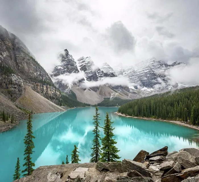 Framed Print : Cloudy mountain peaks, reflection in turquoise glacial lake Framed Print : Cloudy mountain peaks, reflection in turquoise glacial lake