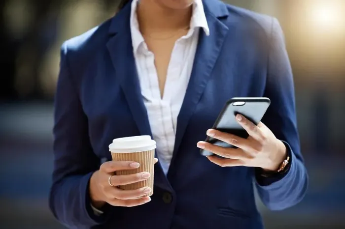 Framed Print : Coffee break and phone in hands of a business woman reading email
