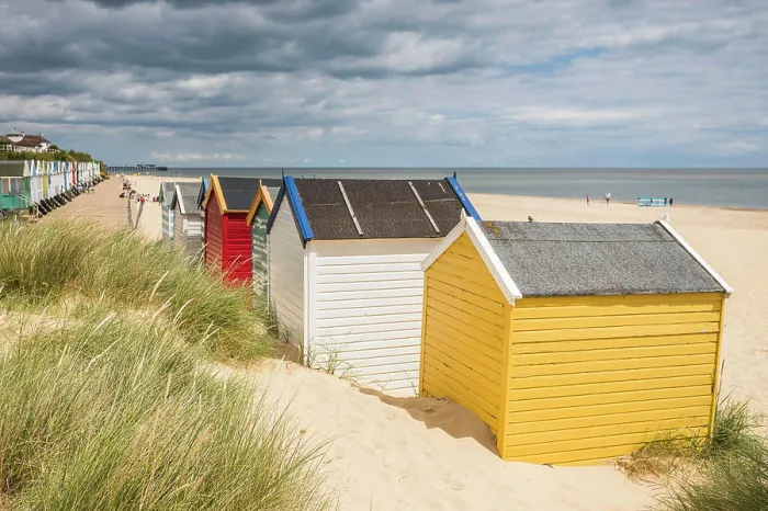 Framed Print : Colourful beach huts pictured behind dune grass at the end of the promenade at Southwold beach on the Suffolk coast Framed Print : Colourful beach huts pictured behind dune grass at the end of the promenade at Southwold beach on the Suffolk coast