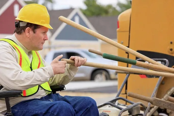 Framed Print : Construction supervisor with Spinal Cord Injury counting work tools on construction site Framed Print : Construction supervisor with Spinal Cord Injury counting work tools on construction site