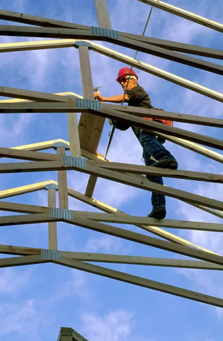 Framed Print : Construction worker using wood trusses for roof frame in Boise, Idaho Framed Print : Construction worker using wood trusses for roof frame in Boise, Idaho